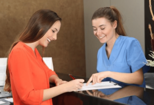 A patient reading a remainder about a dental appointment.