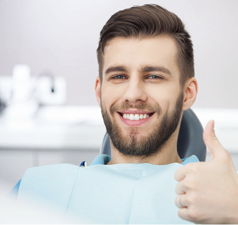 A man smiling after a successful root canal