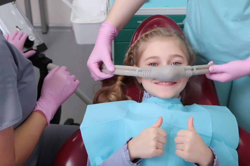 A young girl comfortable with sedation dentistry